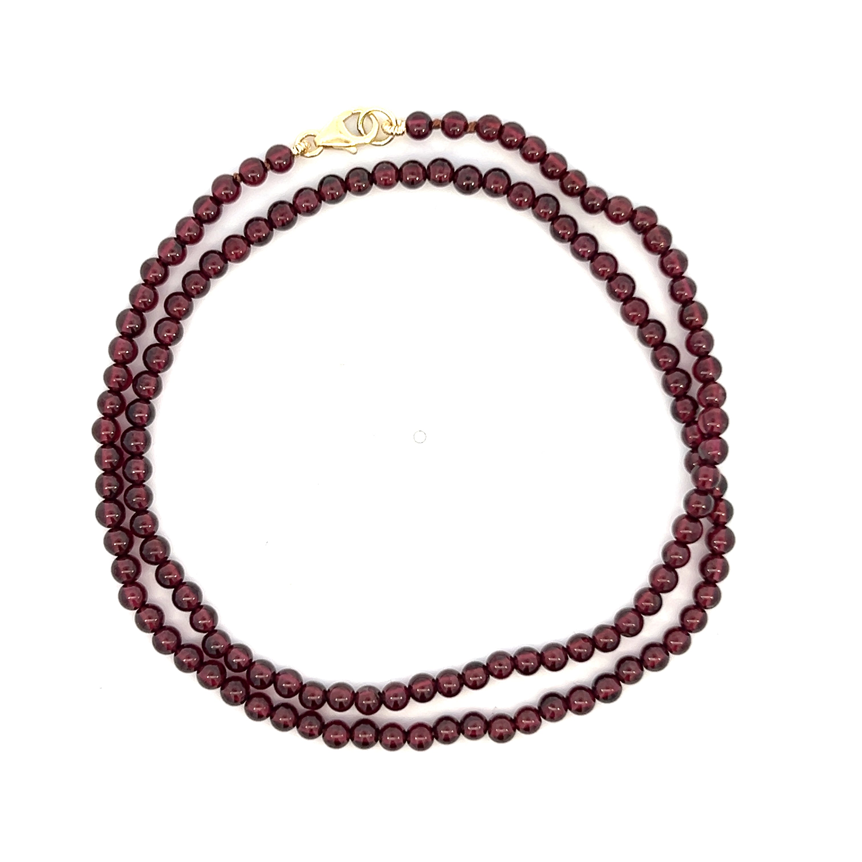 A close-up image of a gold ring featuring a large, oval-shaped blue gemstone set in a four-prong setting, with a simple, polished gold band.