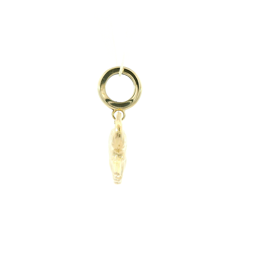 Gold charm with a circular top and textured bottom on a white background