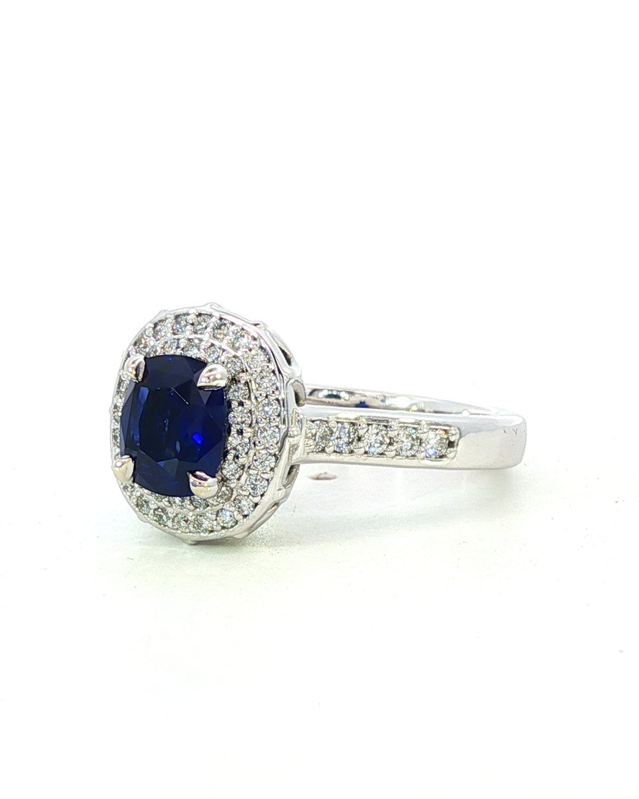 Diamond ring with a blue gemstone on a white background