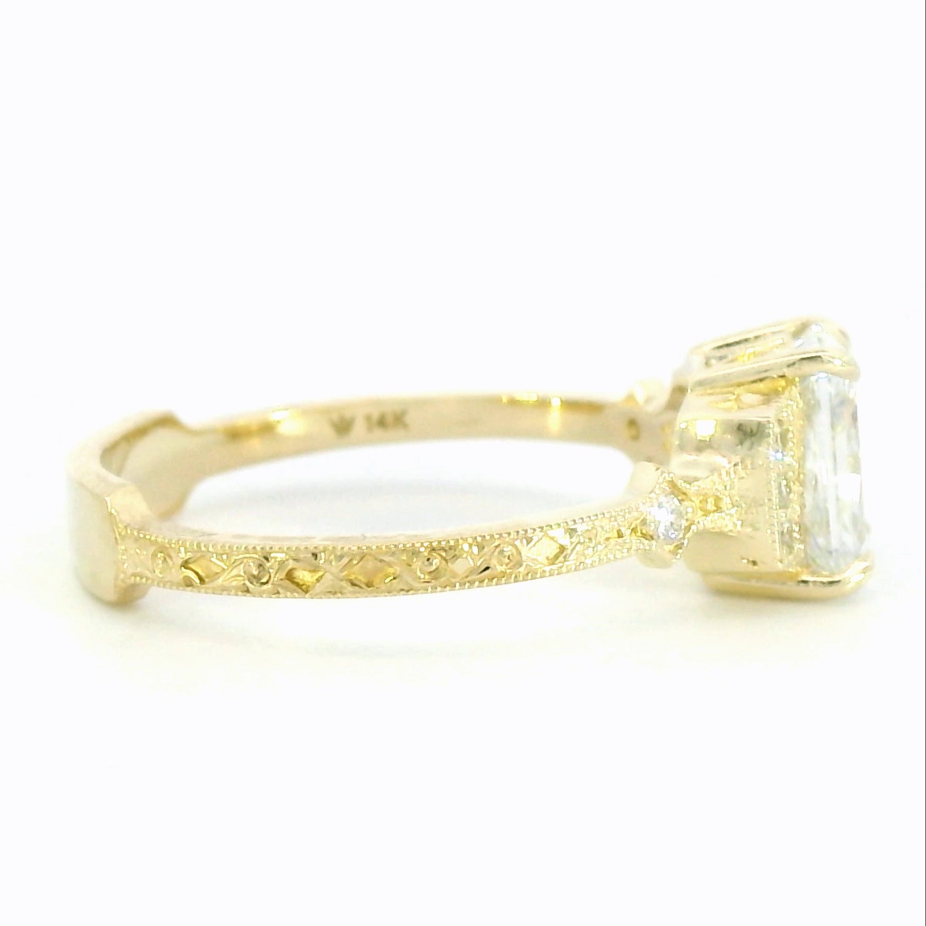 Gold ring with a large diamond on a white background