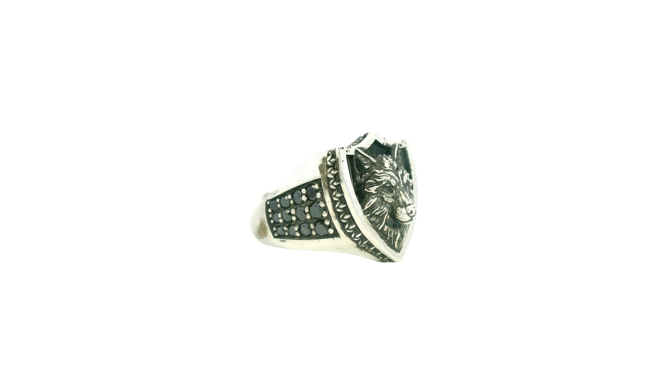 Silver ring with wolf design on a white background