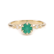 A 14K solid yellow gold ring featuring a vivid green emerald centerpiece in a fairytale-inspired setting, photographed from the front against a plain background.